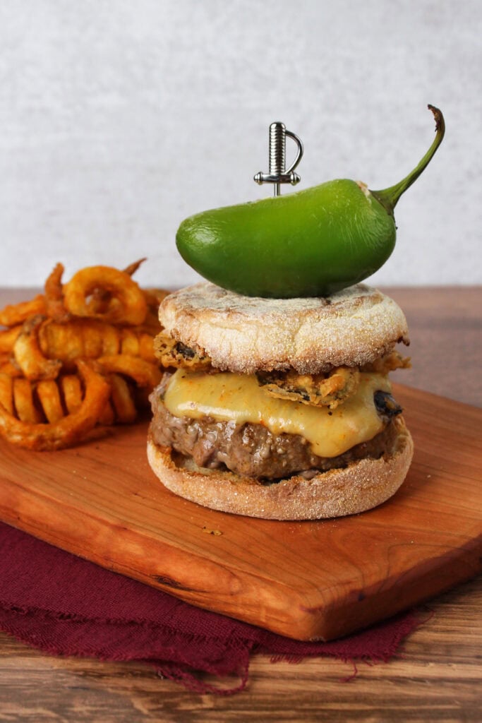 A spicy burger topped with a jalapeno popper.