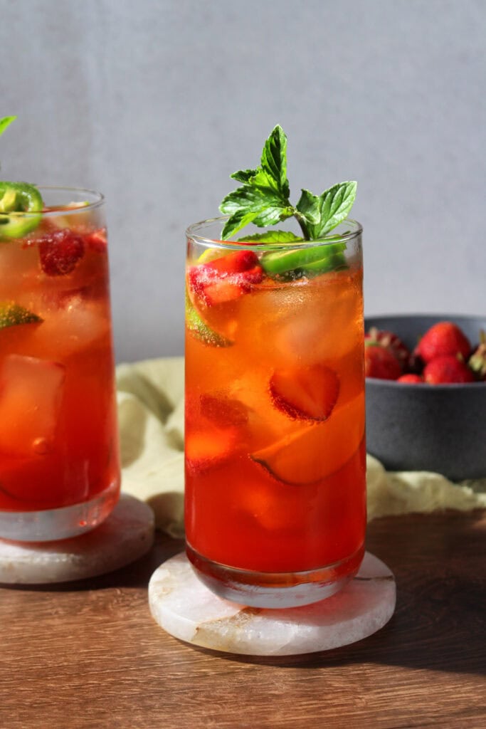 Strawberry jalapeno mojitos garnished with fresh mint.