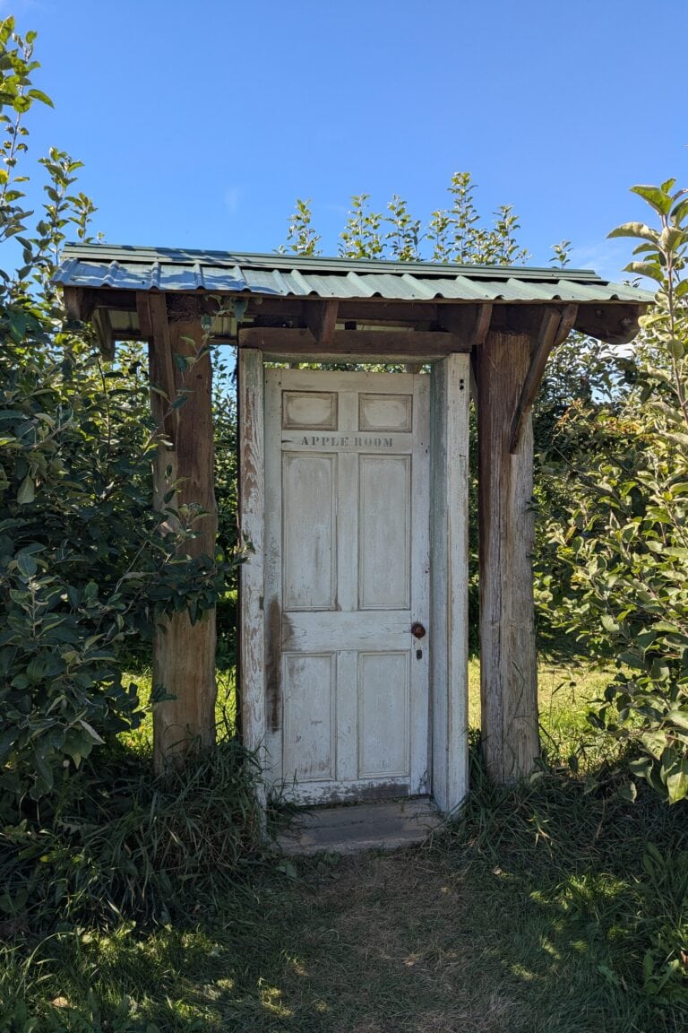A door to an apple orchard.
