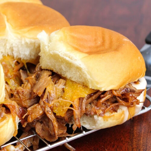 Pulled pork slider on a Hawaiian roll with cheddar cheese.