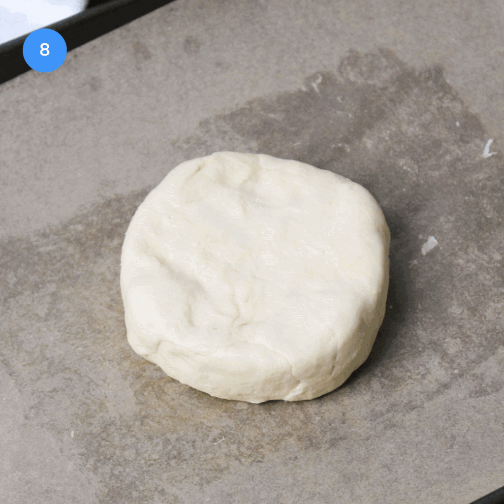 A fully encased baked brie en croute before baking.