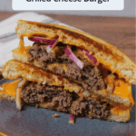 Two halves of a grilled cheese burger stacked on top of one another with a title overlaid.