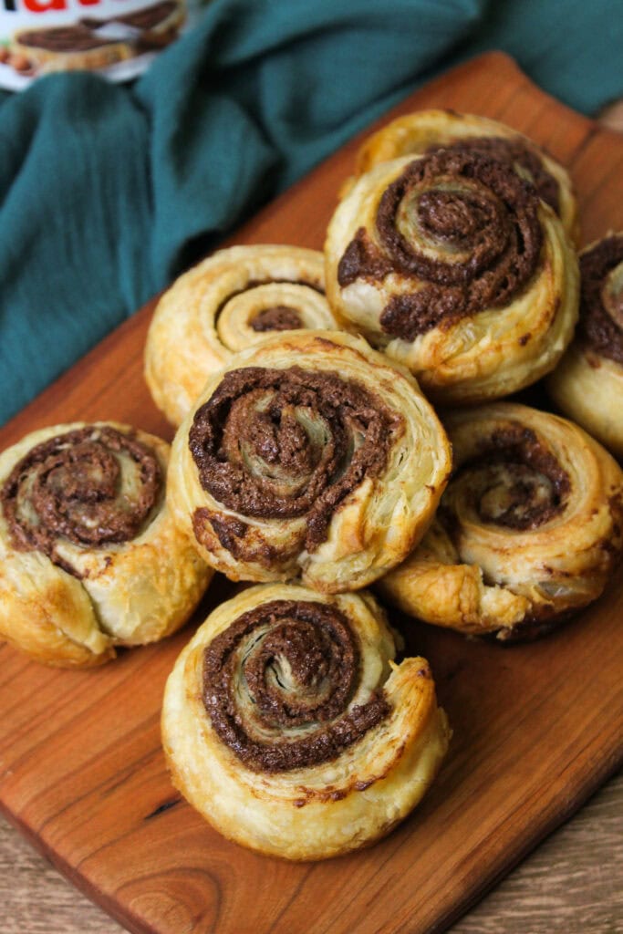 Nutella puff pastry swirls on a serving board.