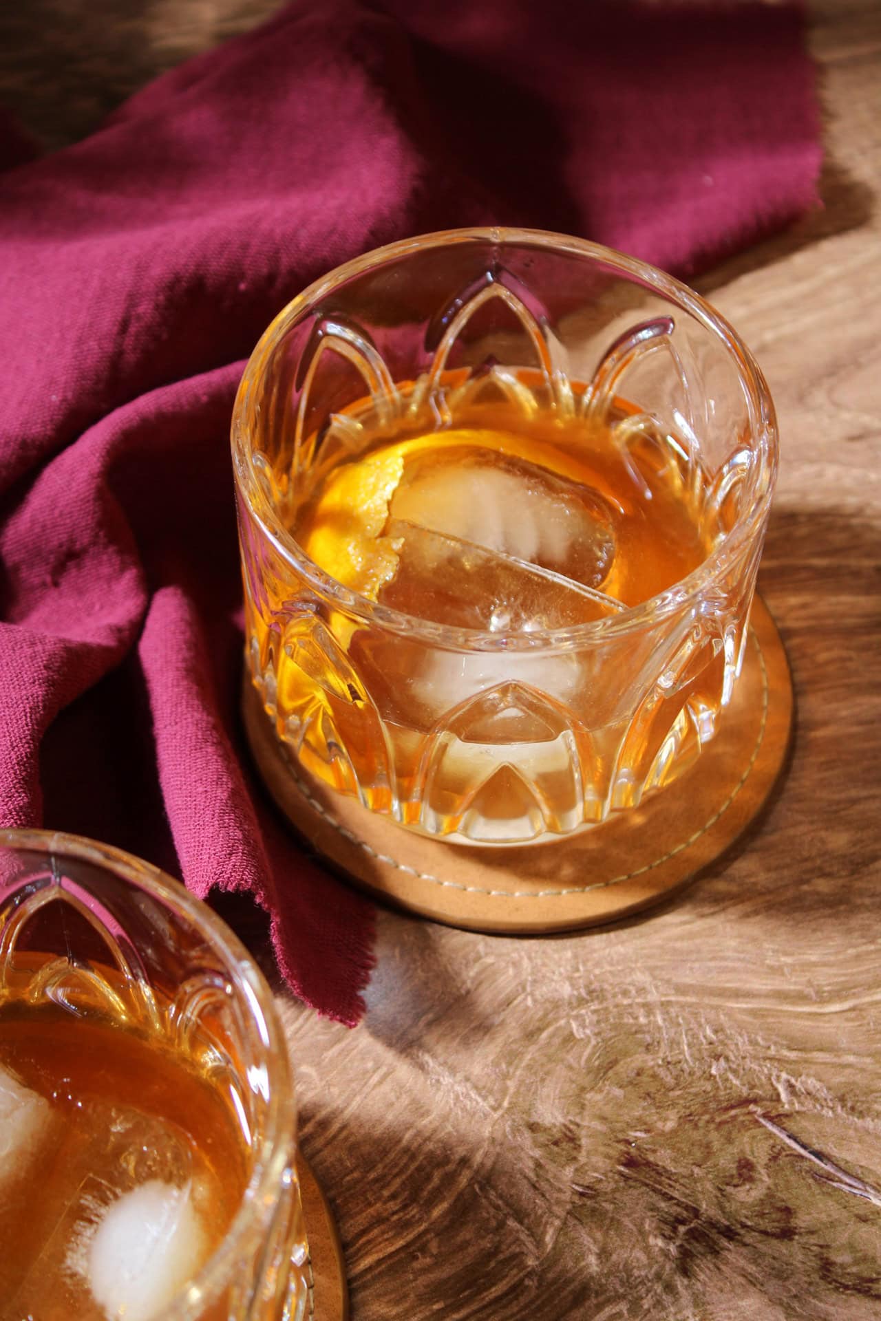 A tequila old fashioned with an orange peel garnish.