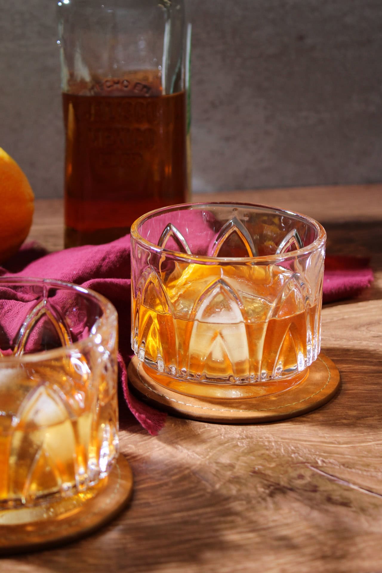 Anejo tequila old fashioned in a crystal low rocks glass.