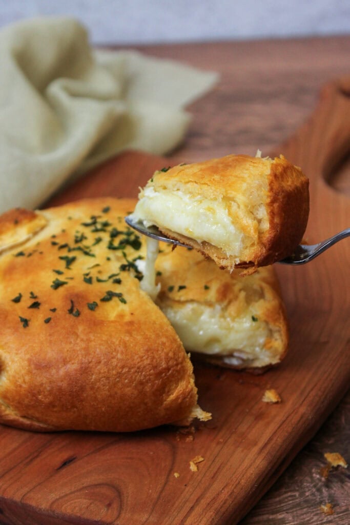 A wedge of baked brie en croute.