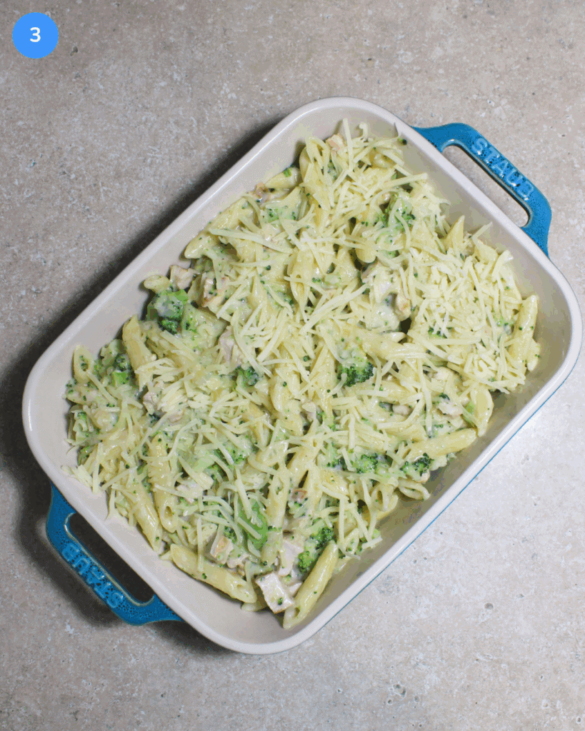 A ceramic baking dish with broccoli chicken pasta bake in it.