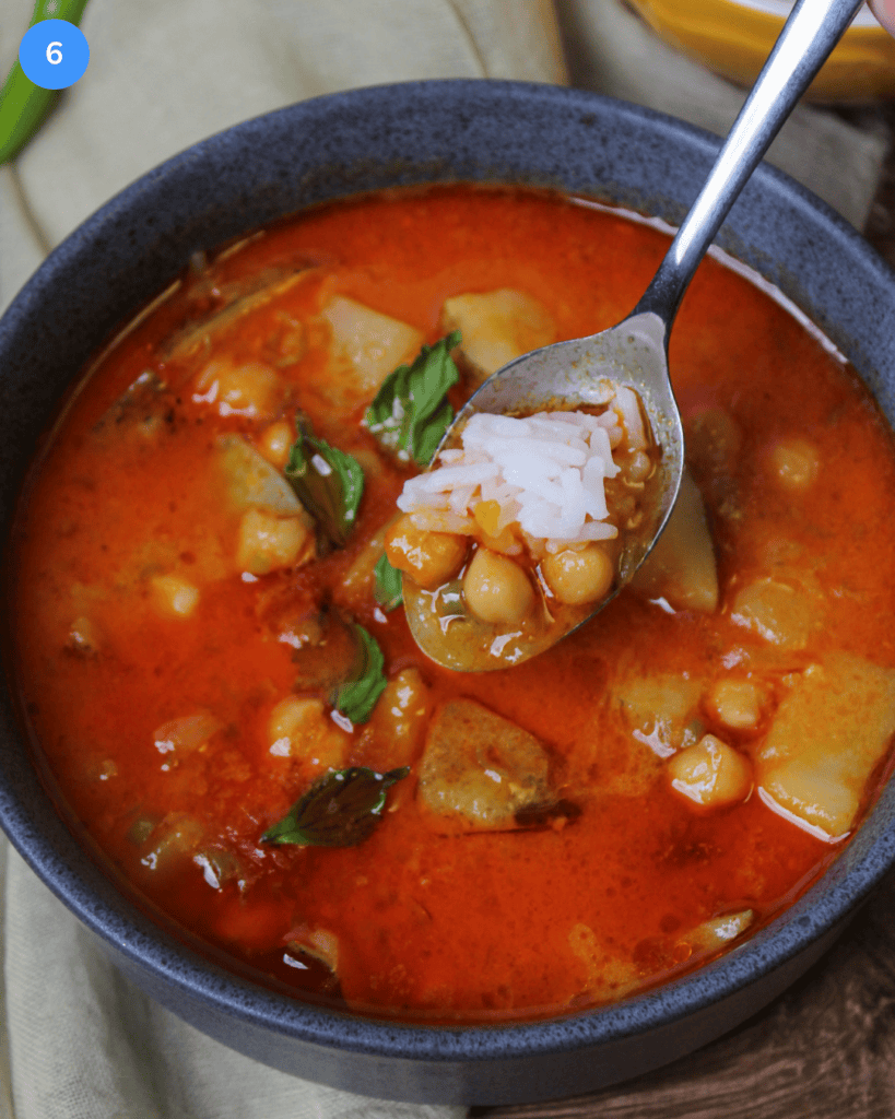A hot bowl of red Thai curry with chickpeas, potatoes, and jasmine rice.