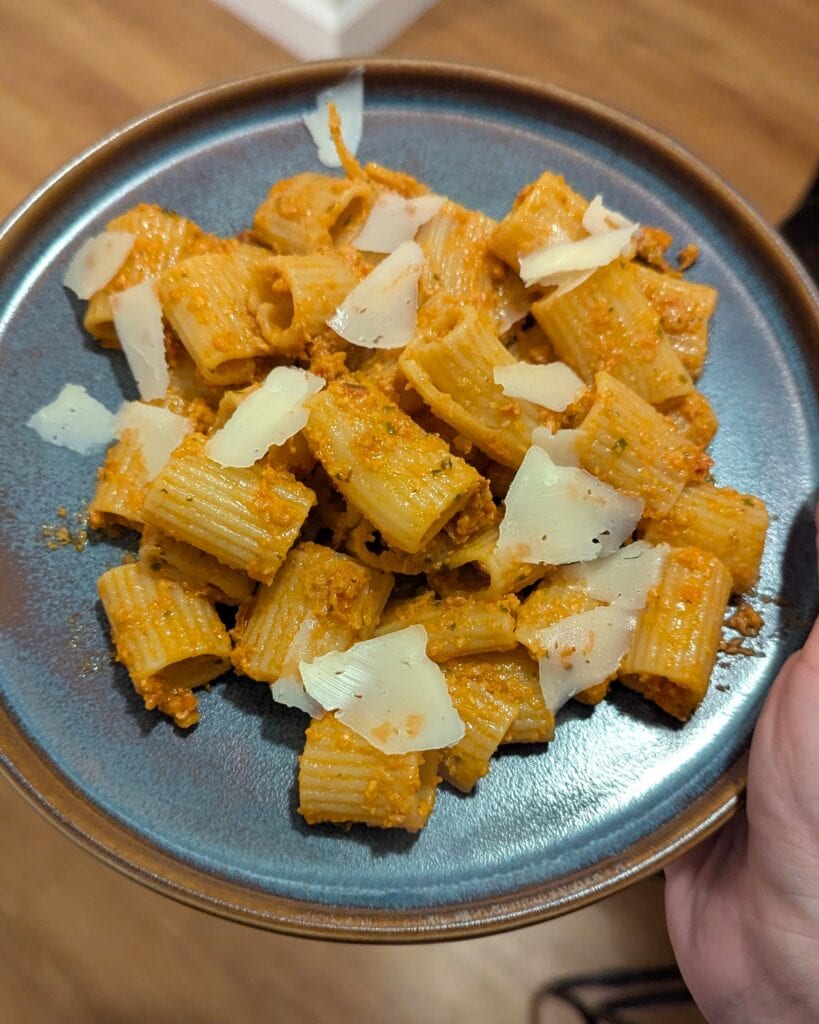 A plate of sun dried tomato pesto pasta.
