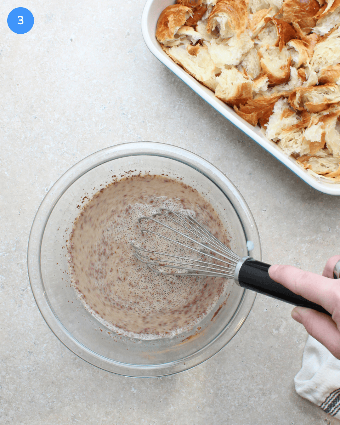A glass bowl of french toast custard being whisked.