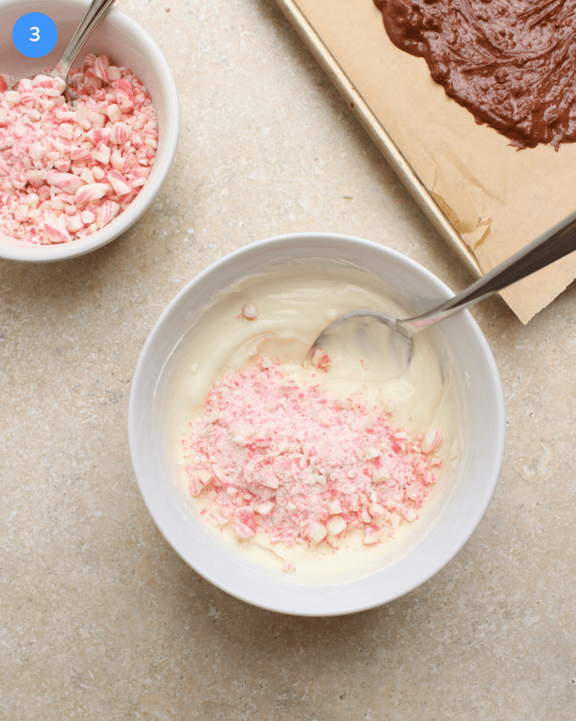A bowl of melted white chocolate and crushed candy canes.
