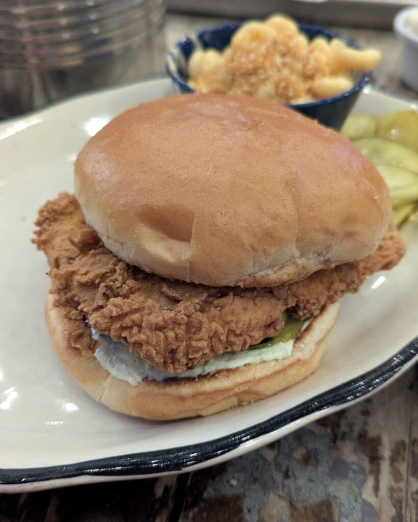 A crispy fried chicken sandwich on a bulkie roll.