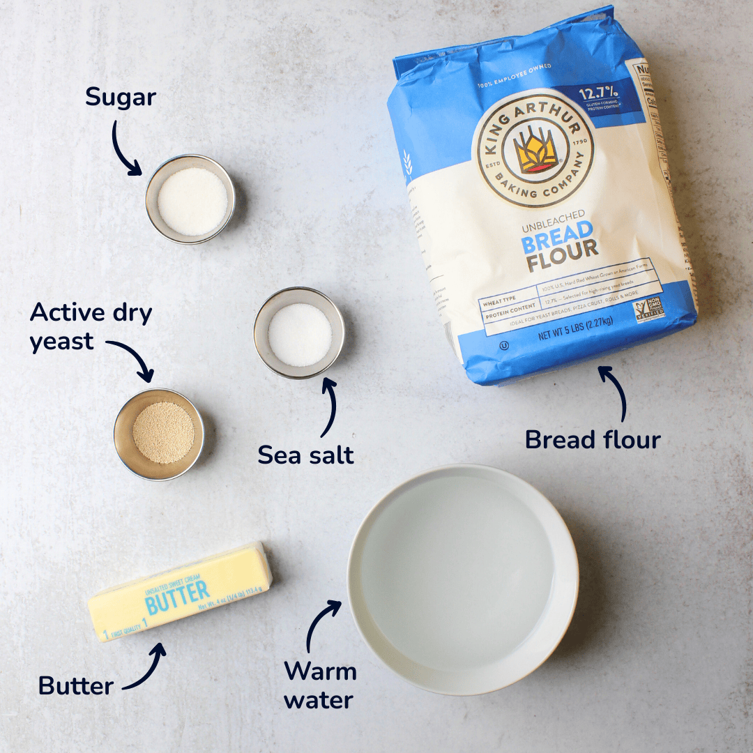 Ingredients for making overnight bagels: bread flour, warm water, sea salt, active dry yeast, sugar, and butter.