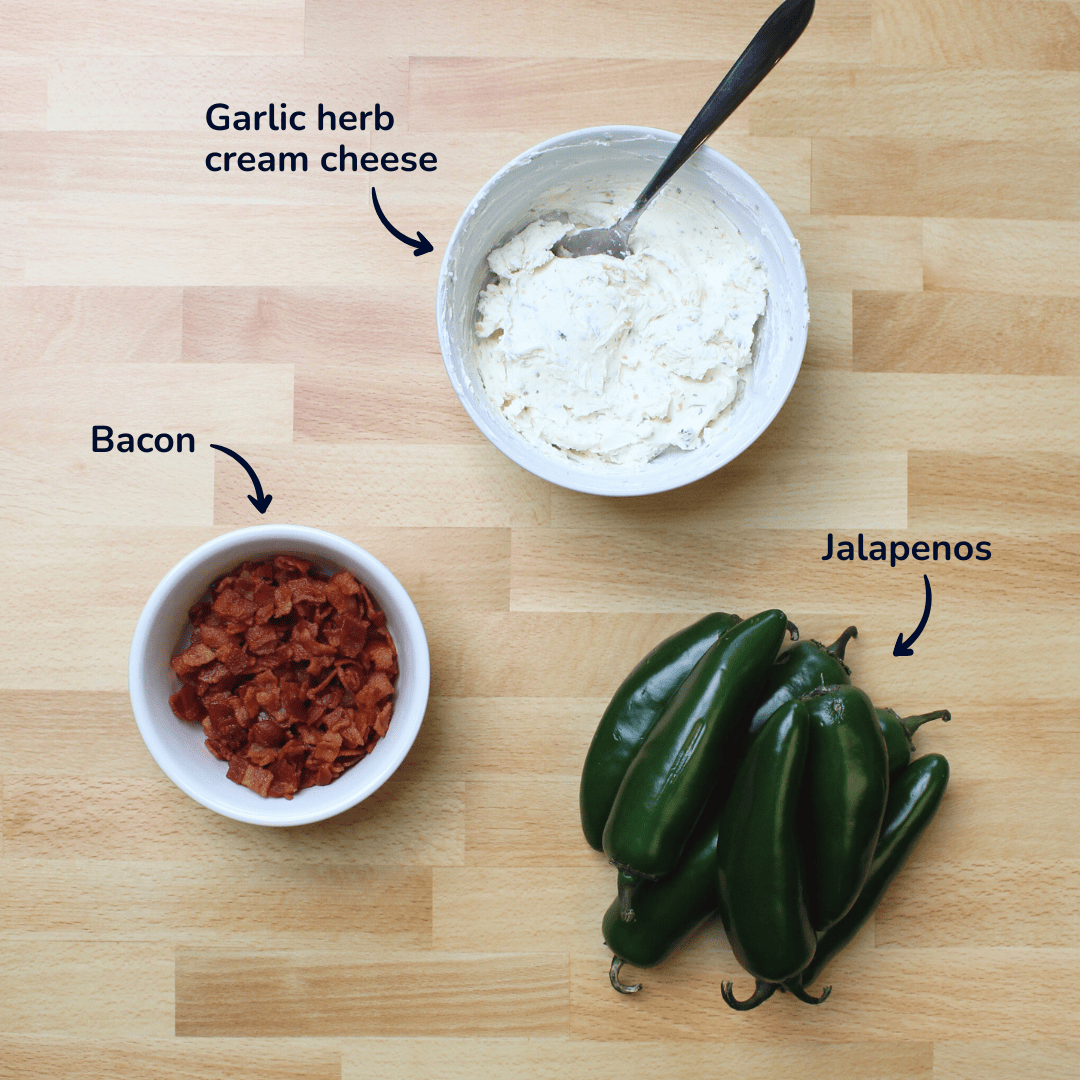 Ingredients for bacon cream cheese jalapeno poppers: diced and fried bacon bits, jalapenos, and garlic herb cream cheese.