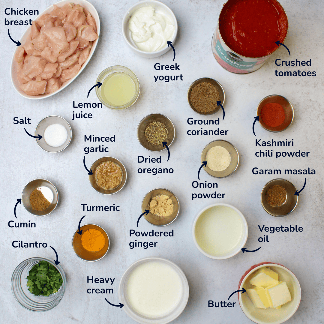 Ingredients for spicy butter chicken: chicken breast, greek yogurt, crushed tomatoes, lemon juice, salt, minced garlic, dried oregano, ground coriander, kashmiri chili powder, garam masala, onion powder, powdered ginger, turmeric, cumin, cilantro, heavy cream, vegetable oil, and butter.