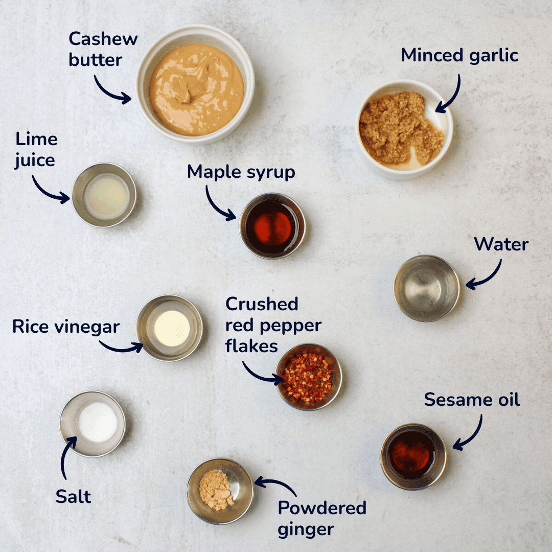Ingredients for Sweetgreen spicy cashew dressing copycat recipe: cashew butter, minced garlic, maple syrup, lime juice, rice vinegar, water, sesame oil, crushed red pepper flakes, salt, powdered ginger.