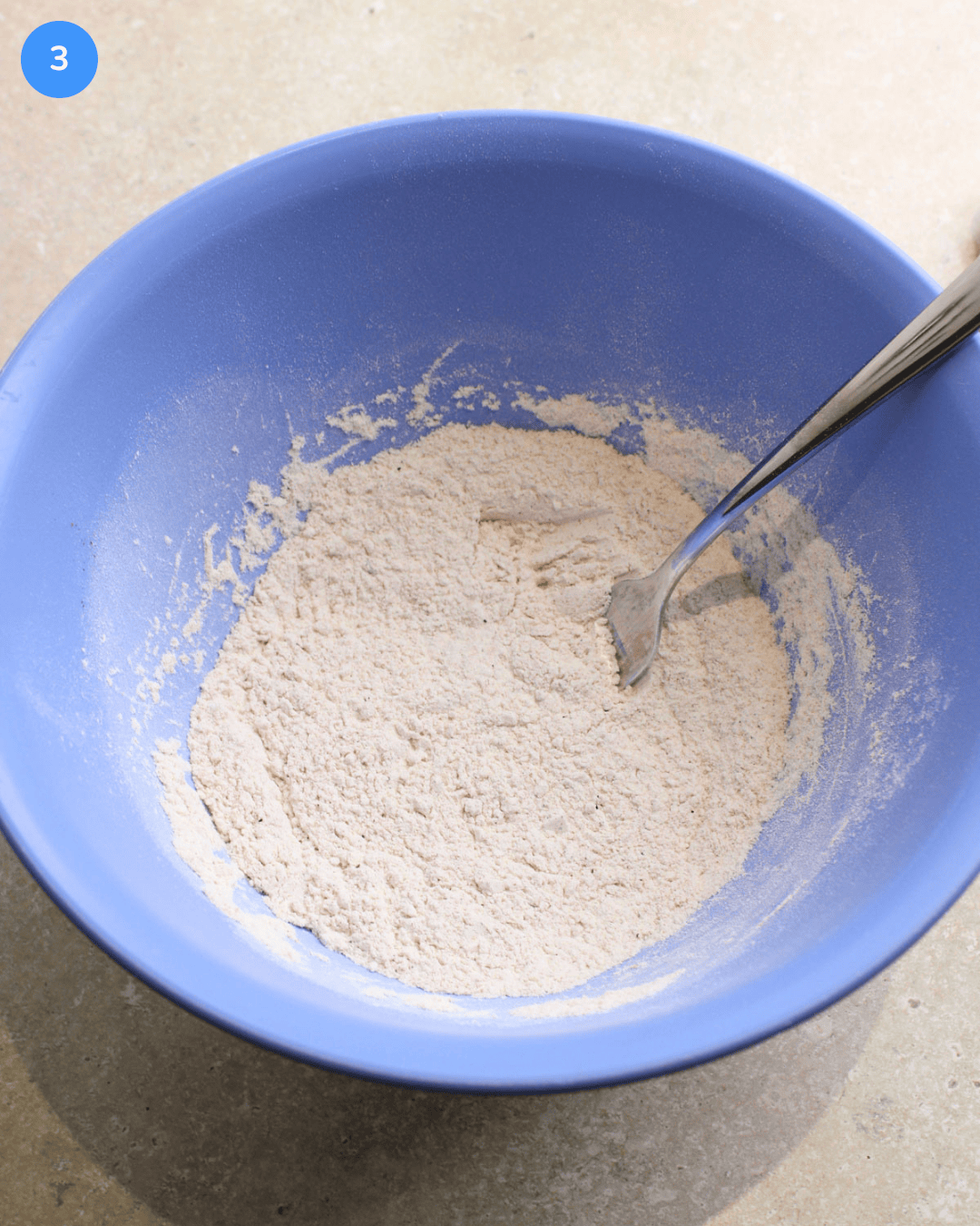 Step 3 for making fried fish tacos. Flour mixed with salt and seasoning in a mixing bowl for dredging the fish.