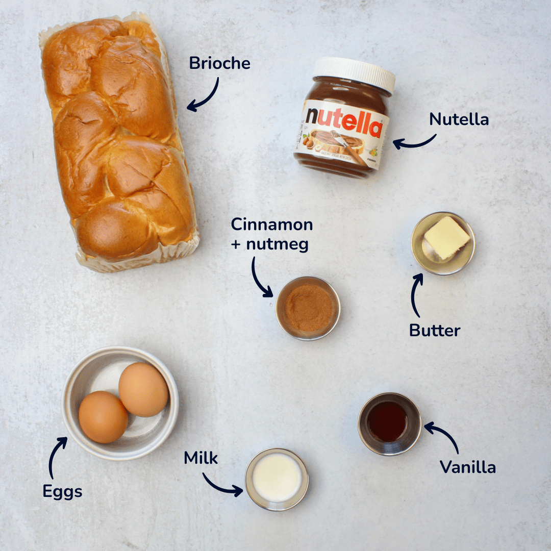 Ingredients for making nutella stuffed french toast: brioche, nutella, cinnamon, nutmeg, butter, vanilla, milk, and eggs.