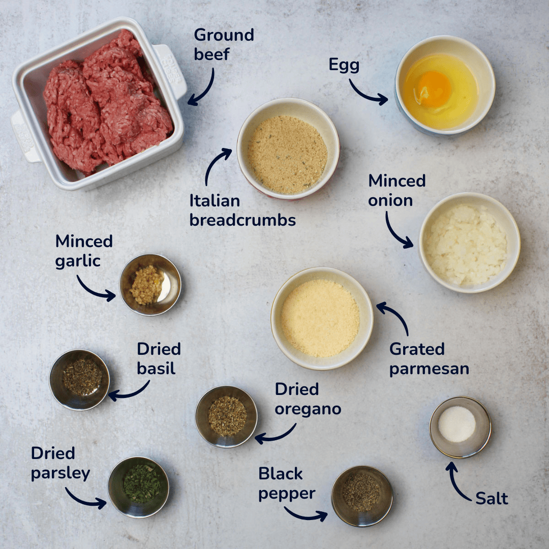 An ingredients shot of Italian meatballs: ground beef, egg, breadcrumbs, onion, parmesan, garlic, and seasonings.
