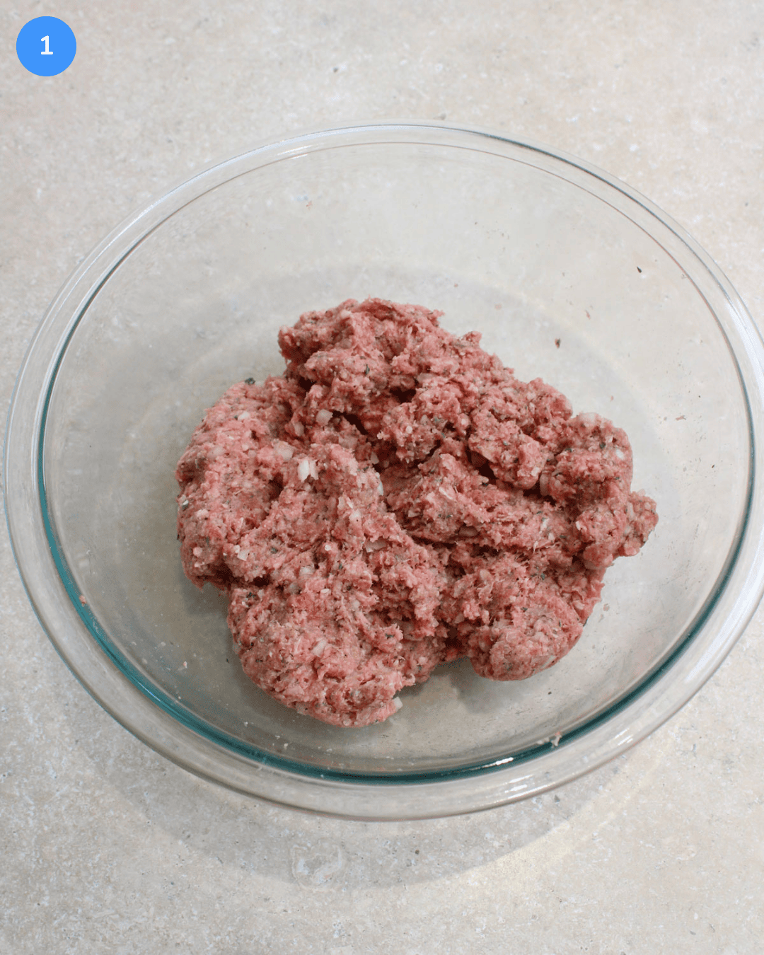 Step 1: Ground beef, egg, breadcrumbs, onion, parmesan, garlic, and seasonings in a large bowl glass mixing bowl mixed together