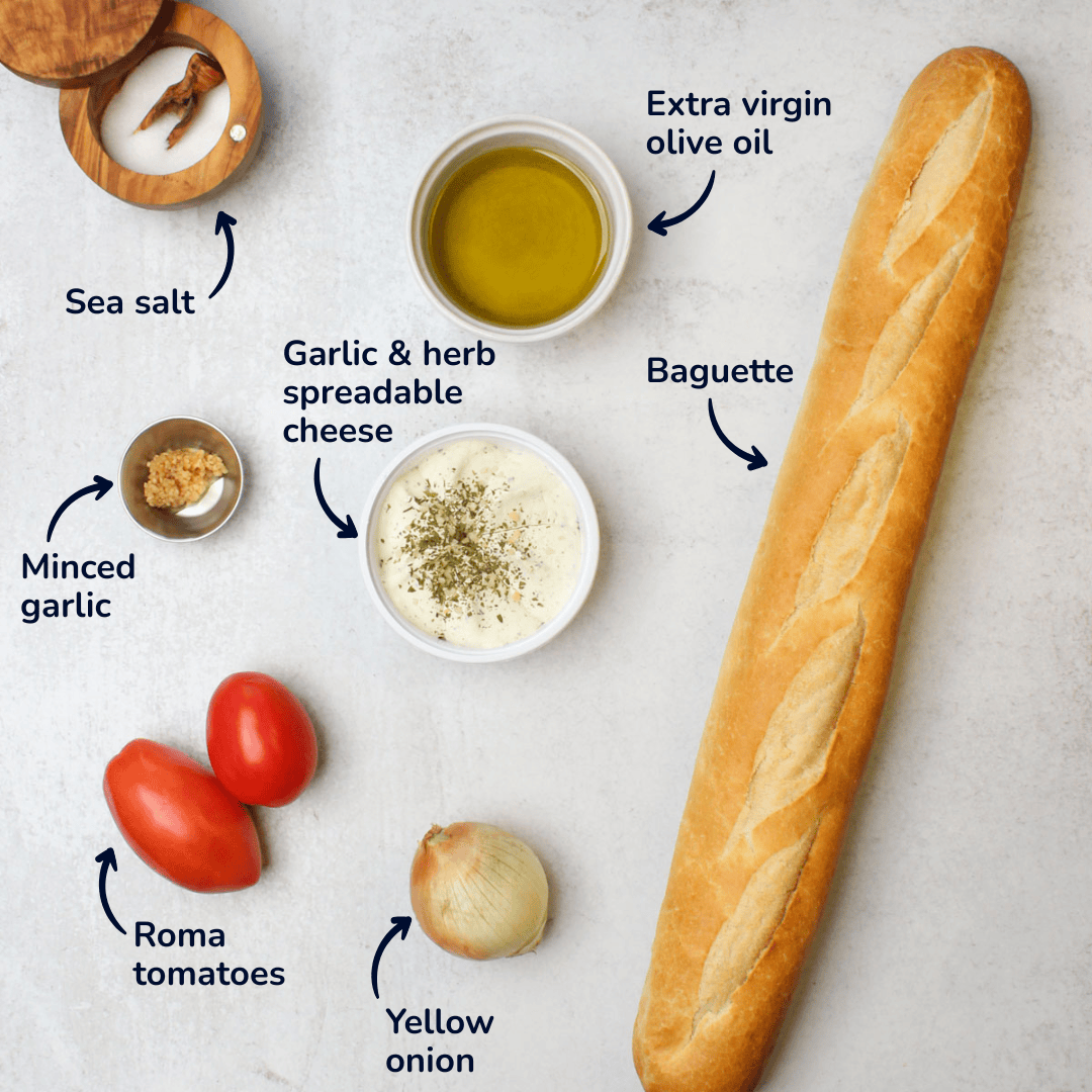 Ingredients for making bruschetta crostini: sea salt, extra virgin olive oil, garlic and herb spreadable cheese, minced garlic, roma tomatoes, yellow onion, and baguette.