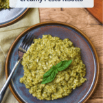 A cover photo for creamy pesto risotto with the title overlaid on a plate of pesto risotto garnished with fresh basil.