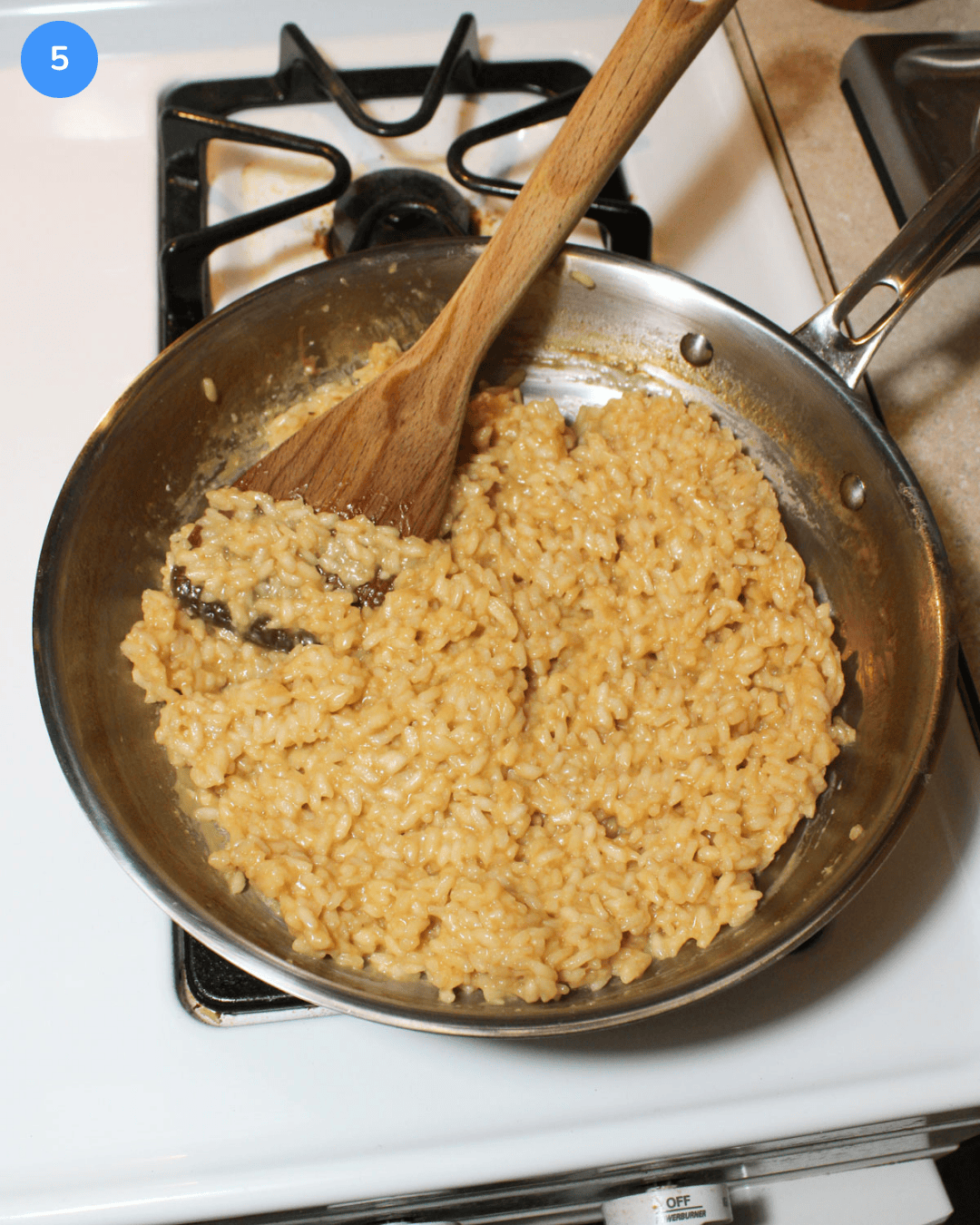 Pesto risotto step 5: the rice having lemon juice, parmesan, and olive oil stirred into it.