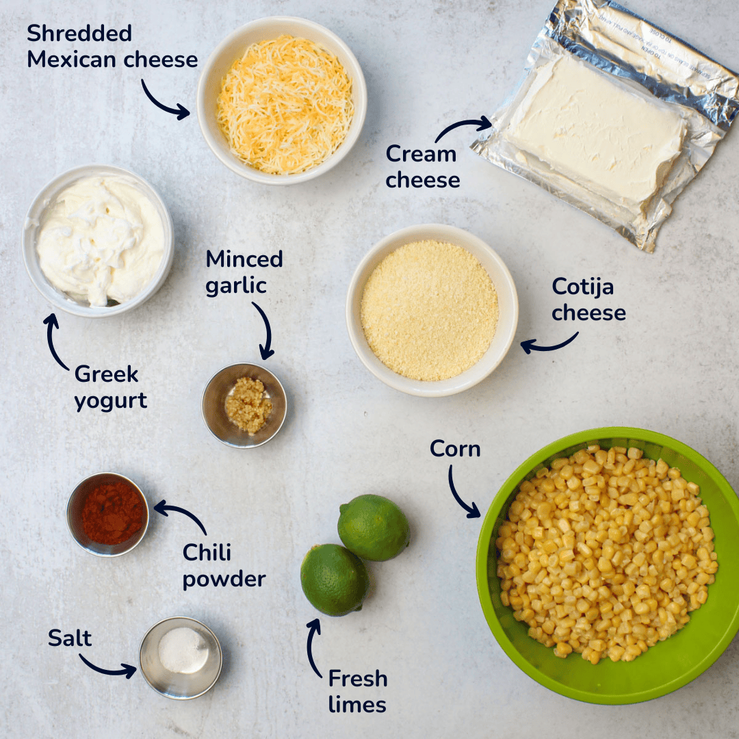 Mexican street corn dip ingredients: Mexican cheese, cream cheese, garlic, cotija, greek yogurt, chili powder, salt, limes, and corn.