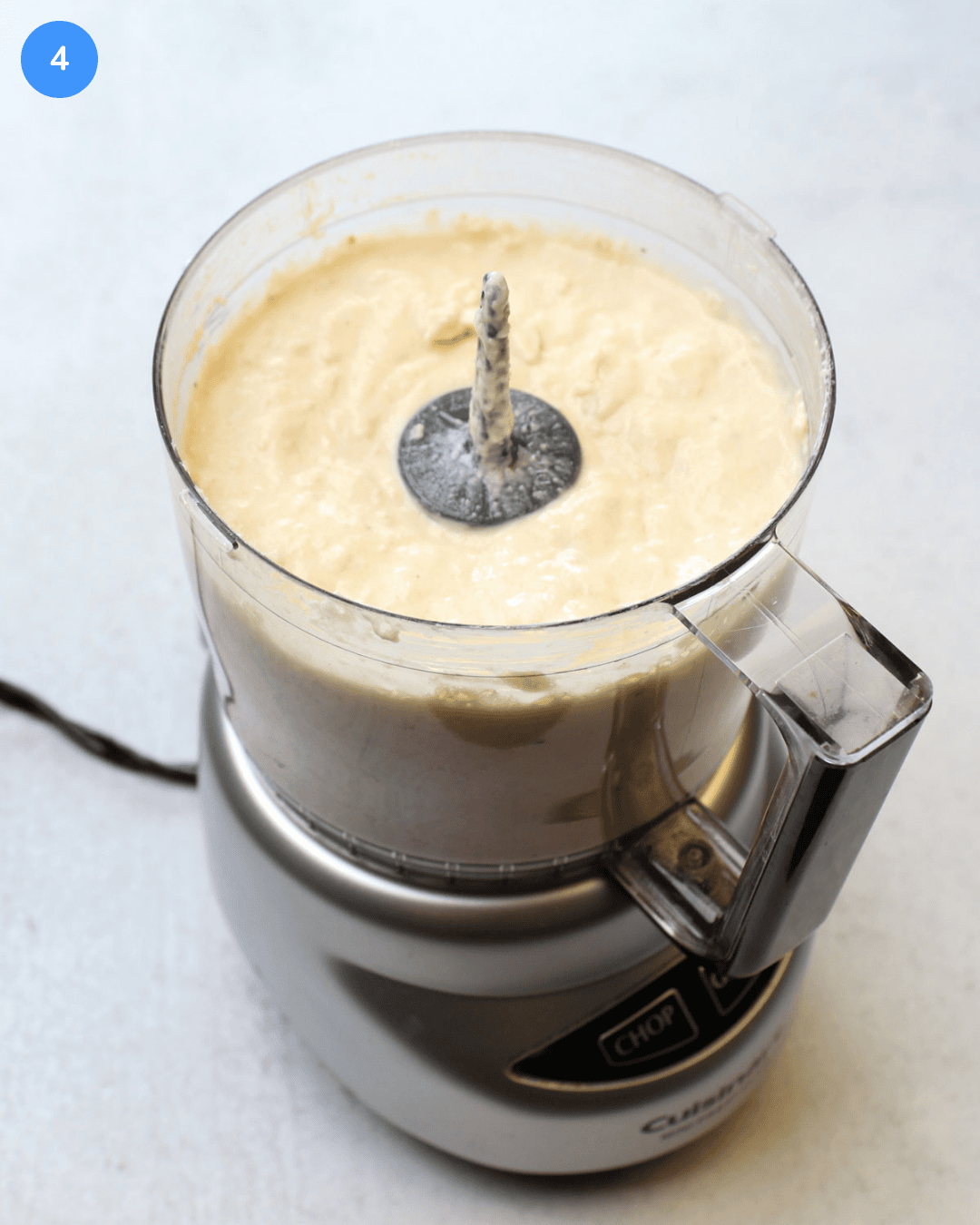 A food processor full of freshly blitzed onion dip.