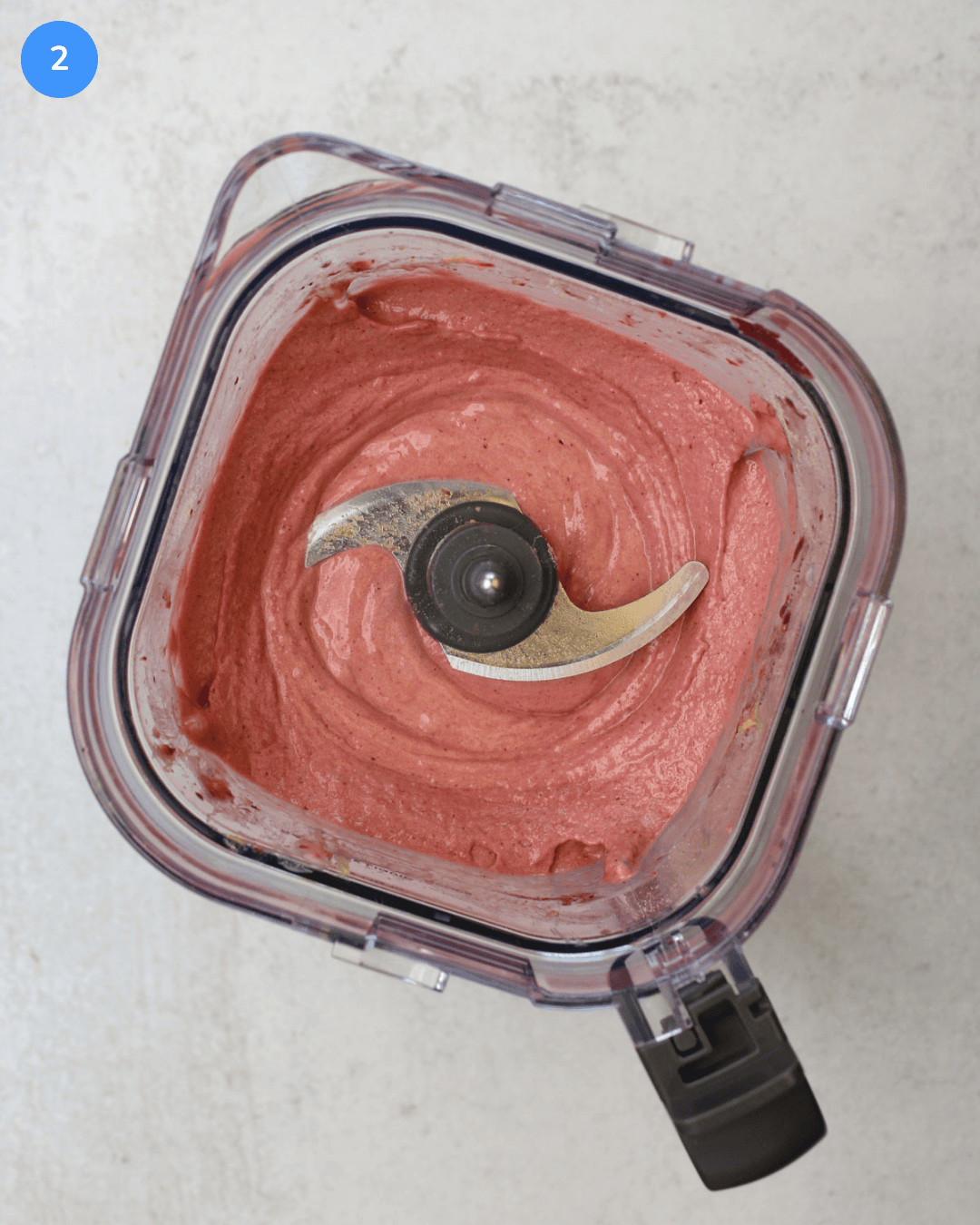 A blender full of freshly blended acai smoothie bowl.