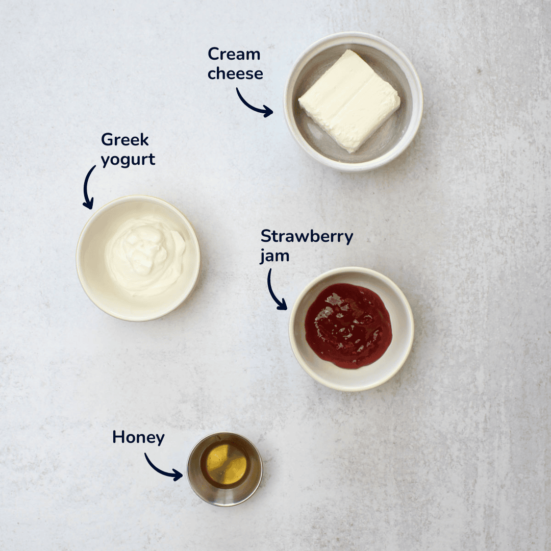 Ingredients for making strawberry fruit dip: cream cheese, greek yogurt, strawberry jam, and honey.
