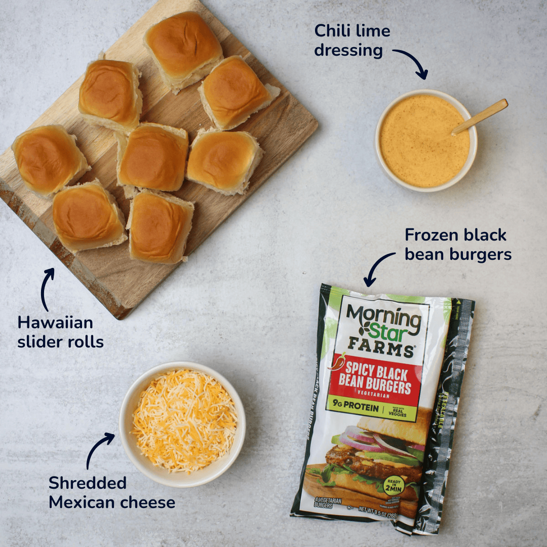 Ingredients for making black bean sliders: hawaiian slider rolls, shredded mexican cheese, frozen black bean burgers, and chili lime dressing.