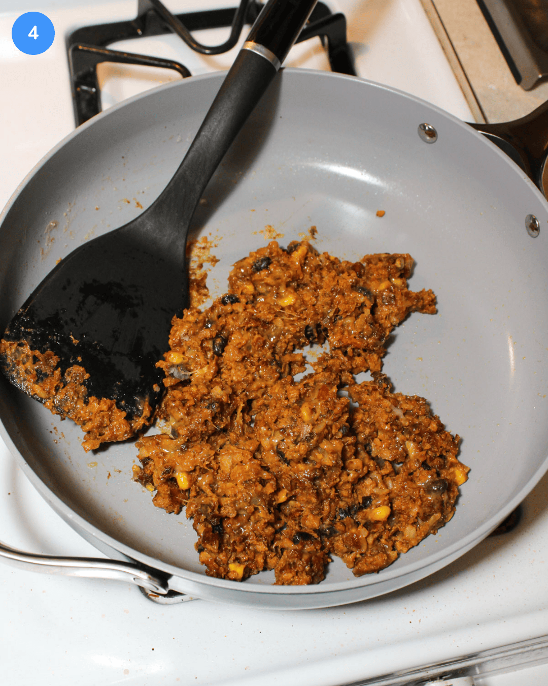 A black bean southwest slider mixture in a ceramic frying pan on the stove.