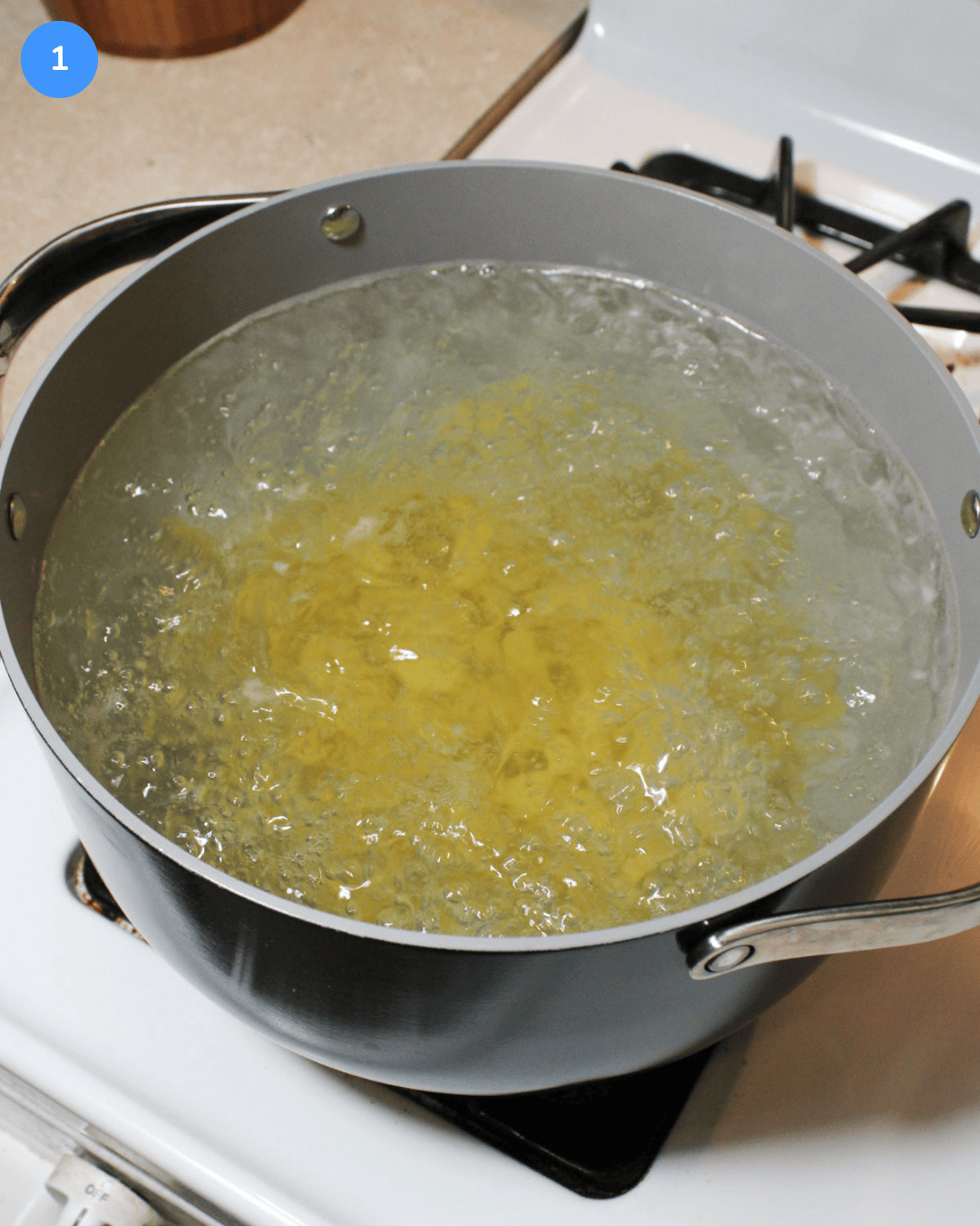 A large pot of boiling pasta on the stove.