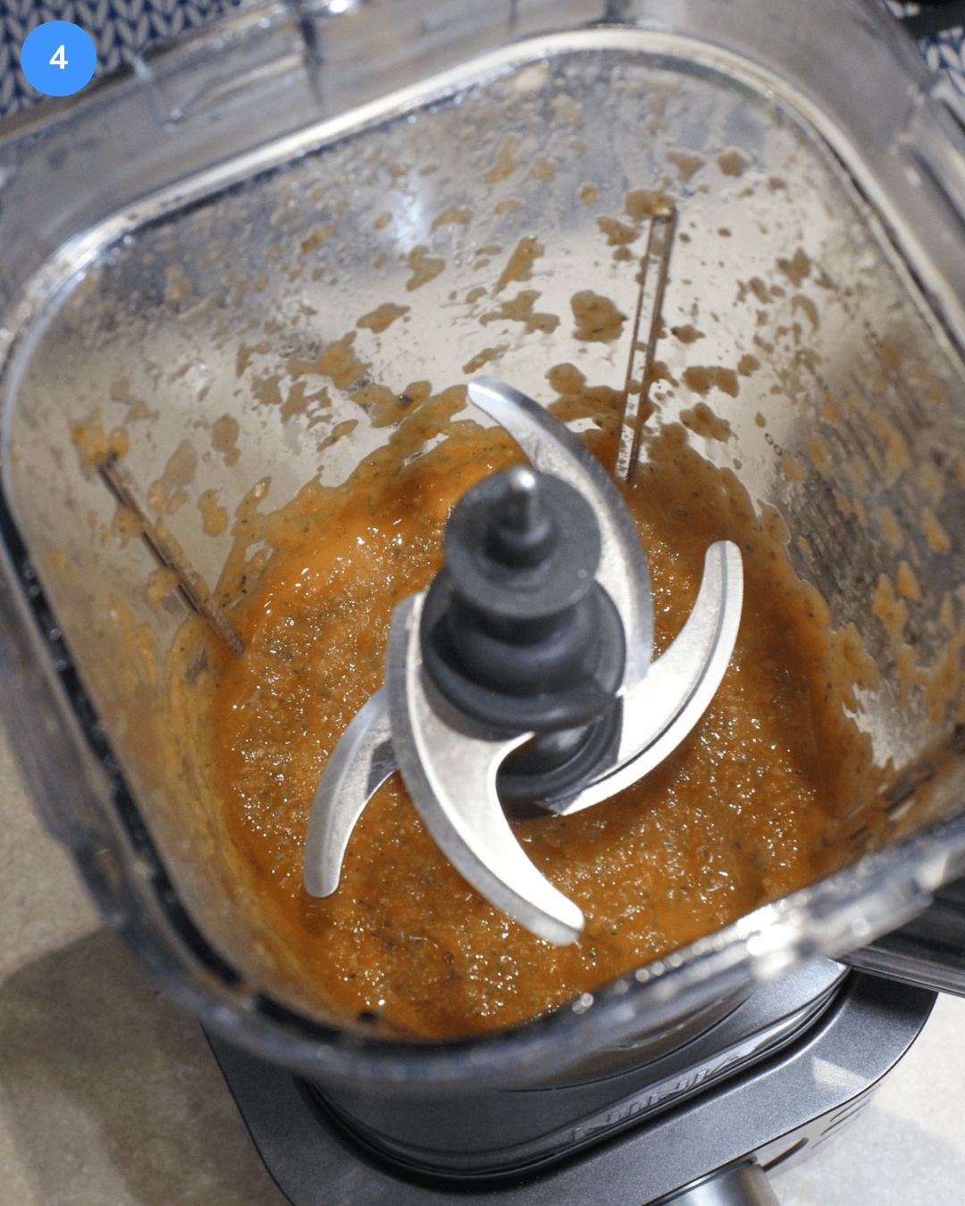 A blender filled with freshly made zucchini tomato pasta sauce.