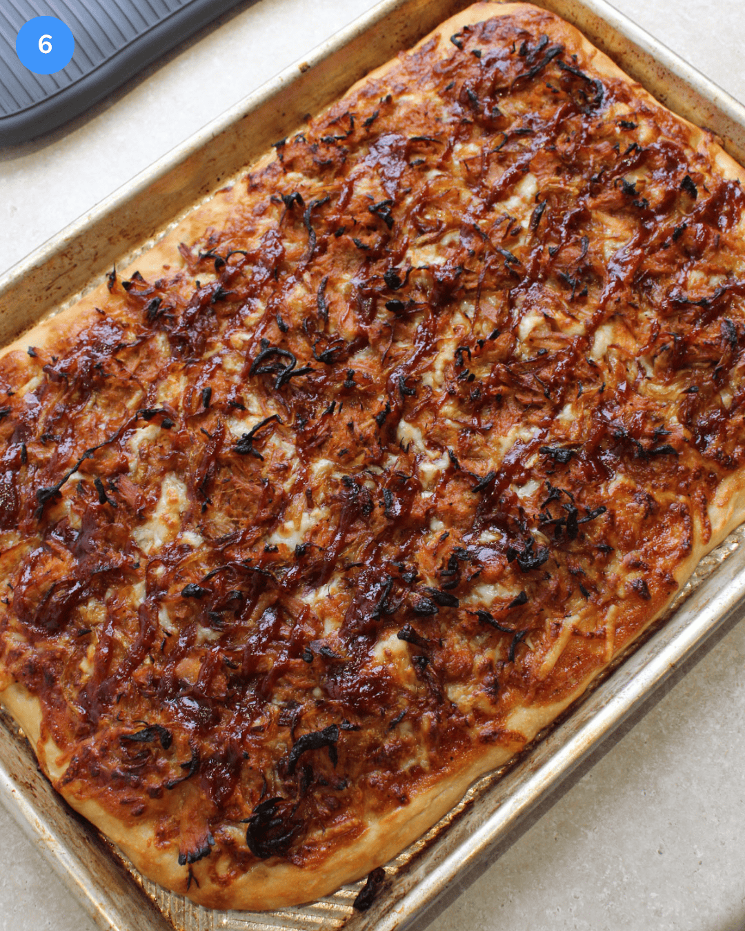 A freshly baked barbecue pulled pork pizza with golden brown crust.