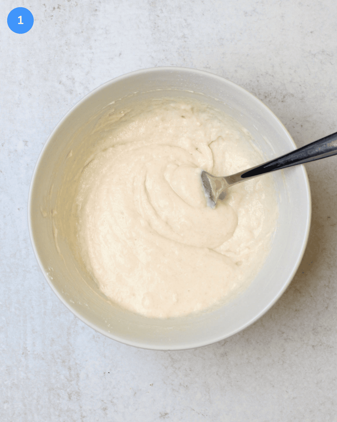 A pancake mix batter in a white ceramic bowl.