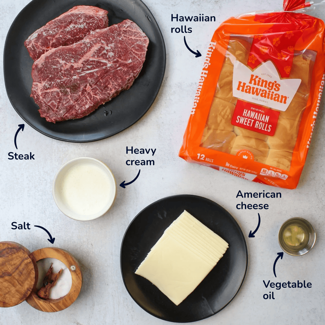 Ingredients for making Philly cheesesteak sliders: steak, heavy cream, American cheese, salt, vegetable oil, hawaiian rolls.