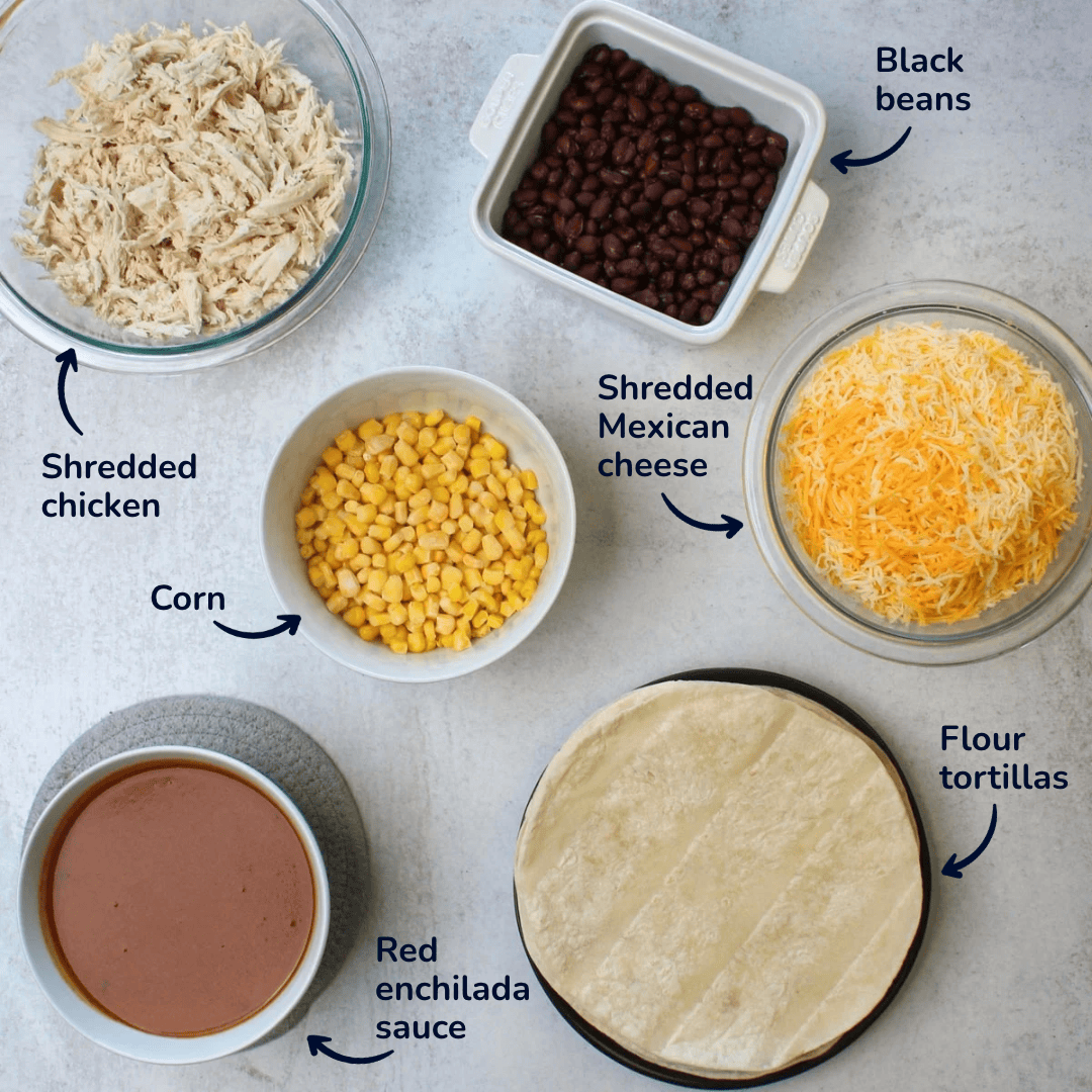 Ingredients for making red chicken enchiladas: shredded chicken, black beans, corn, shredded mexican cheese, flour tortillas, and red enchilada sauce.