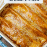 A tray of freshly baked saucy, cheesy red chicken enchiladas with a title overlaid.